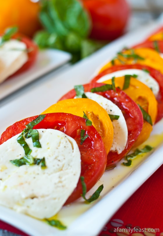 A simple recipe for Caprese Salad - fresh, garden tomatoes, mozzarella, basil -- so simple and so delicious!