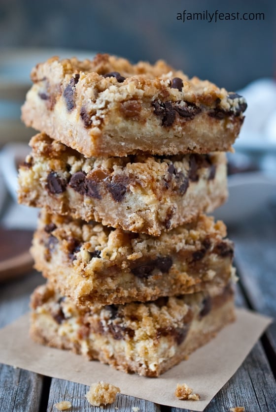 Chocolate Chip Caramel Crumble Bars - A delicious oatmeal cookie crust, cream cheese filling with chocolate chips and caramel bits, and a light cookie crumble topping. These are fantastic!