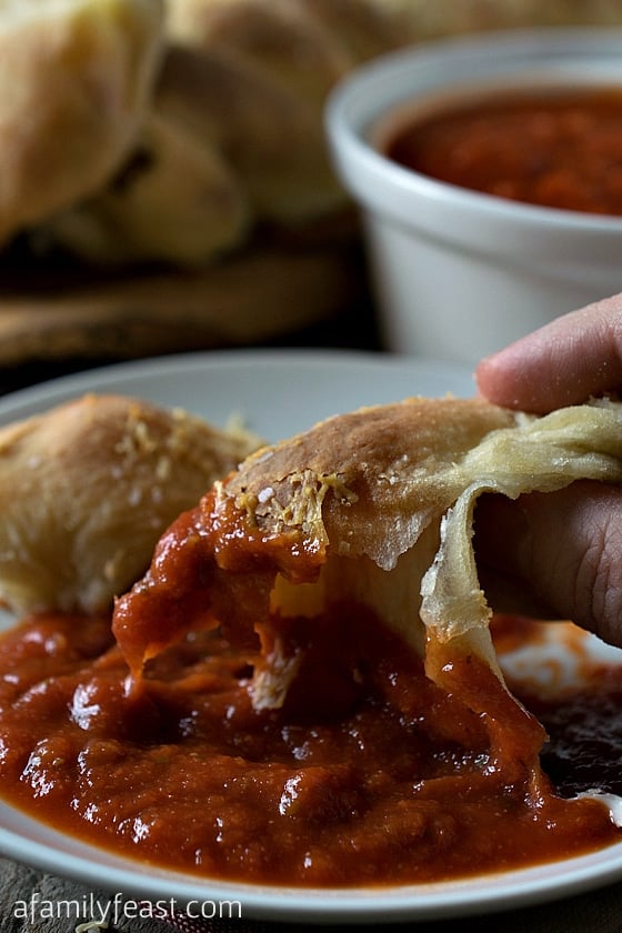Stuffed Crust Pizza Braid - This delicious and cheesy braid of pizza dough dipped in marinara sauce makes a delicious light dinner or appetizer!