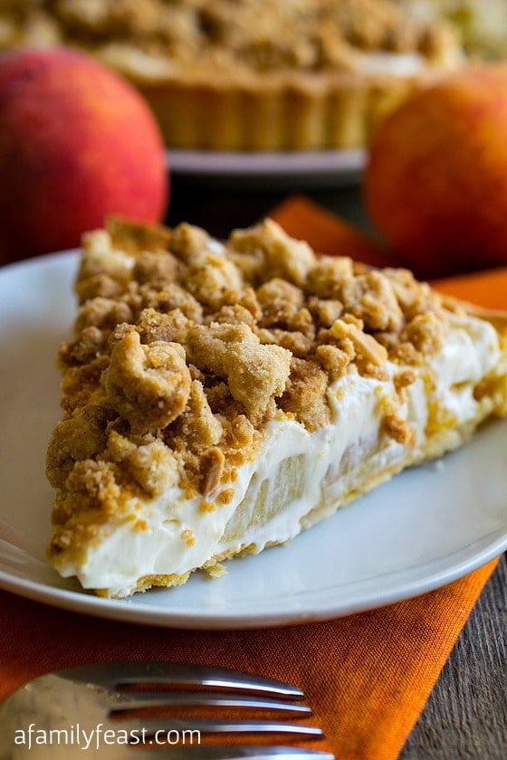 Peaches and Cream Almond Crumb Tart - Shortbread cookie crust filled with sweet cream cheese and diced peaches with a sweet almond crumb top! So delicious!