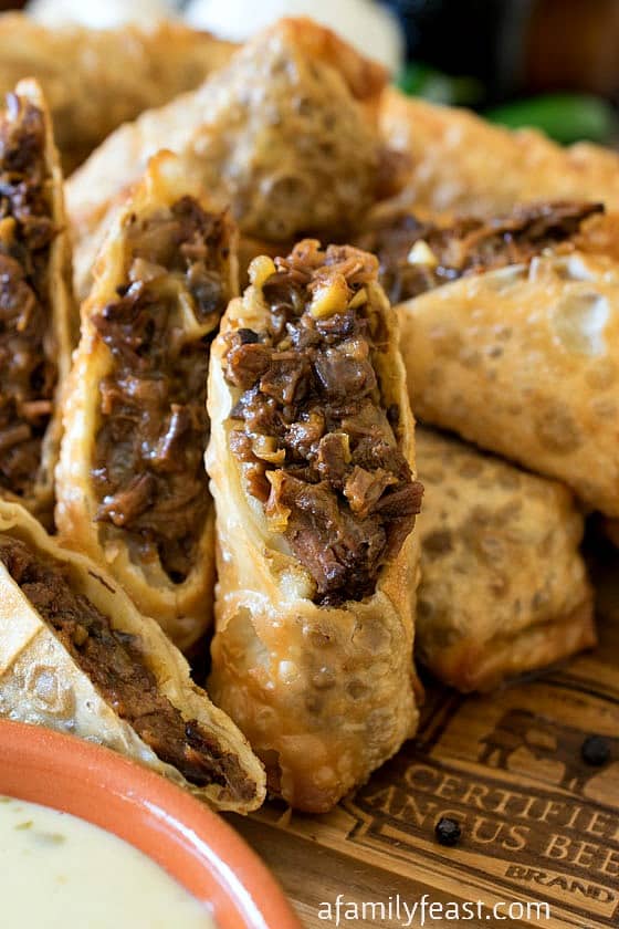 Cheesesteak Egg Rolls - Tender shredded beef brisket in crispy fried egg rolls, served with a zesty queso dipping sauce. Amazing!