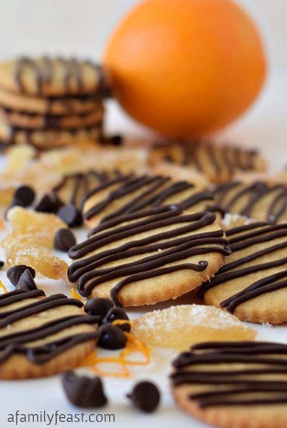 Orange and Ginger Cookies with Chocolate Drizzle - A sweet orange sugar cookie with crystallized ginger added for some sweet spiciness - plus orange-chocolate drizzle over the top! So delicious!