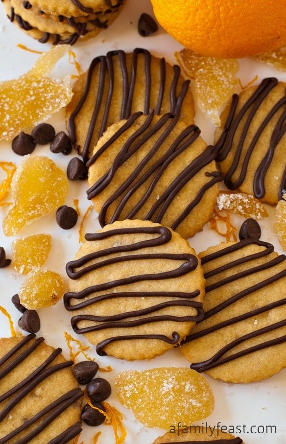 Orange and Ginger Cookies with Chocolate Drizzle - A sweet orange sugar cookie with crystallized ginger added for some sweet spiciness - plus orange-chocolate drizzle over the top! So delicious!