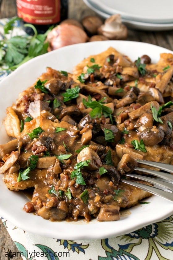 Chicken Marsala - Tender boneless chicken breasts smothered in the perfect salty-sweet Marsala wine sauce with mushrooms and pancetta. Delicious!