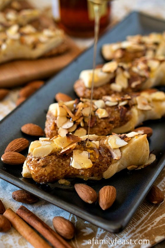 Sicilian Twists - A rich sweet Italian shortbread cookie with an almond, cinnamon and honey filling and topped with a drizzle of honey and more toasted almonds. Perfectly sweet and delicious!