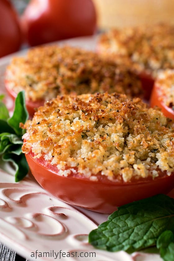 Baked Stuffed Parmesan Tomatoes - A incredible stuffing made from crispy bread crumbs, cheese and garlic is packed into sliced tomato halves, then baked. Super simple and super delicious!