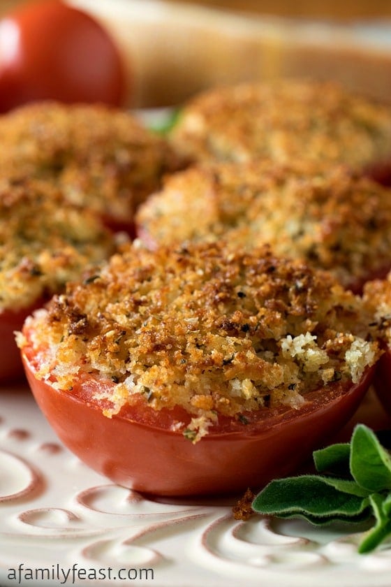 Baked Stuffed Parmesan Tomatoes - A incredible stuffing made from crispy bread crumbs, cheese and garlic is packed into sliced tomato halves, then baked. Super simple and super delicious!