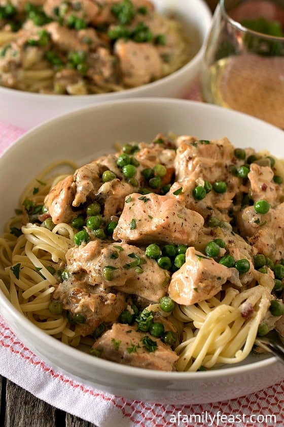 Creamed Salmon and Peas Over Linguini - Tender chunks of salmon sautéed in a wonderful cream and mustard sauce that is flavored with pancetta and shallots, then served over linguini. (It’s incredible!)