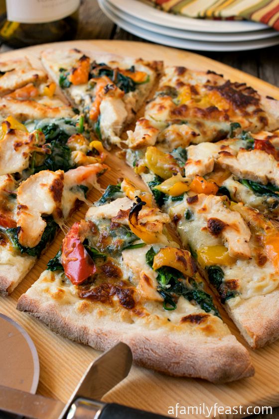Change family pizza night with this delicious White Chicken Pizza! Grilled chicken, creamy white bechamel, pesto, peppers, spinach and mozzarella! Pizza heaven!