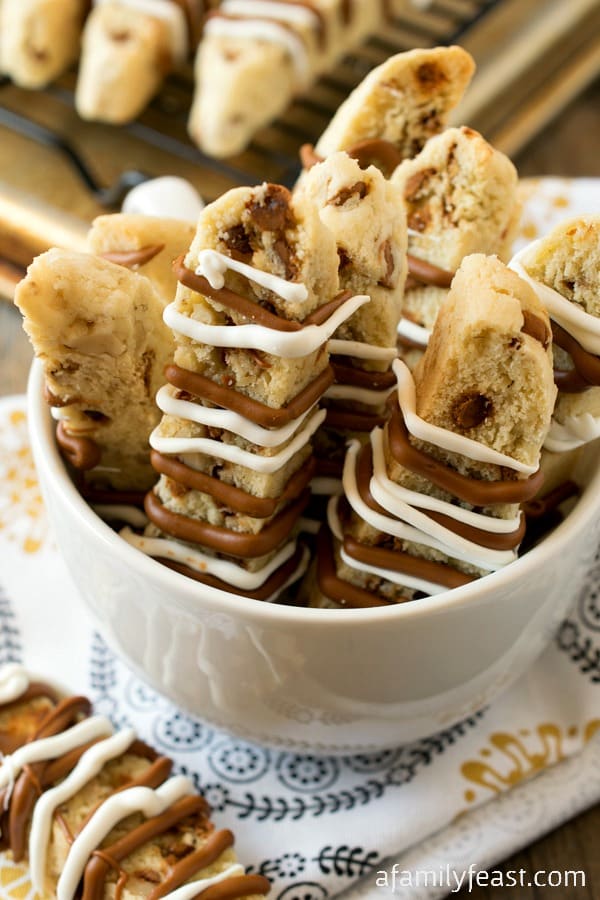 Cinnamon Chip Biscotti - A sweet and spicy biscotti filled with cinnamon chips and walnuts and a white chocolate, cinnamon drizzle on top.