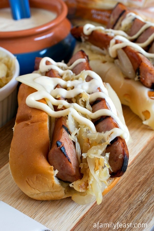 Grilled Kielbasa Rolls with White Barbecue Sauce - Grilled Kielbasa smothered in sauerkraut & onions, swiss cheese and zesty white barbecue sauce - all piled into a KING'S HAWAIIAN Hot Dog Roll! #MakeSummerSweet