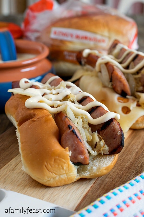 Grilled Kielbasa Rolls with White Barbecue Sauce - Grilled Kielbasa smothered in sauerkraut & onions, swiss cheese and zesty white barbecue sauce - all piled into a KING'S HAWAIIAN Hot Dog Roll! #MakeSummerSweet