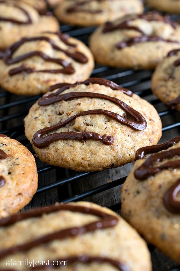 Stuffed Nutella Cookies - Sweet cookies stuffed with a Nutella and hazelnut filling and topped with a drizzle of Nutella ganache. So delicious!