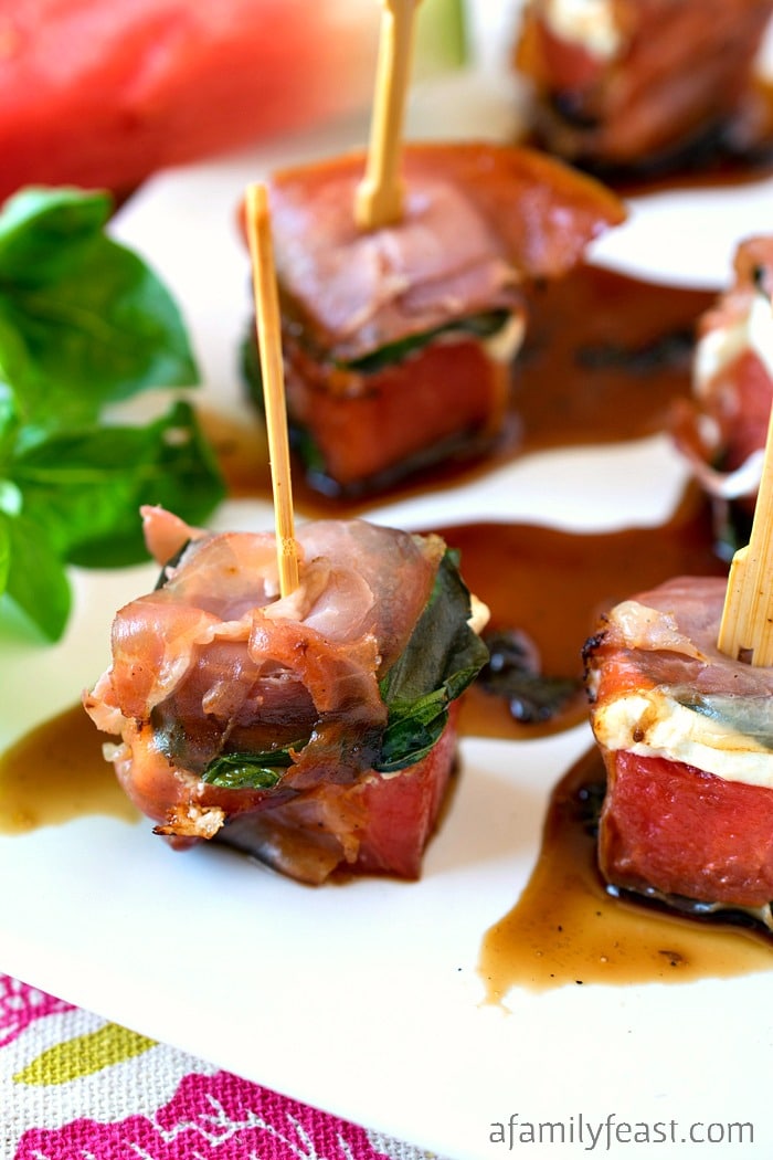 Grilled Watermelon Bites - Chunks of watermelon layered with goat cheese and basil, then wrapped in salty prosciutto. This unique summer appetizer is a must-make recipe!