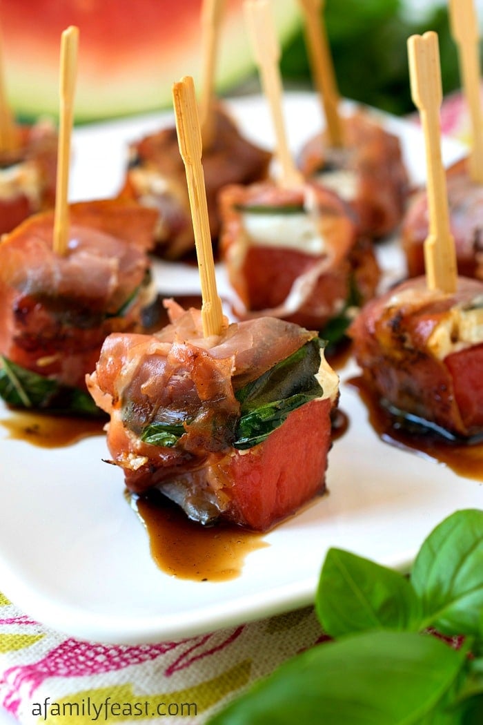 Grilled Watermelon Bites - Chunks of watermelon layered with goat cheese and basil, then wrapped in salty prosciutto. This unique summer appetizer is a must-make recipe!