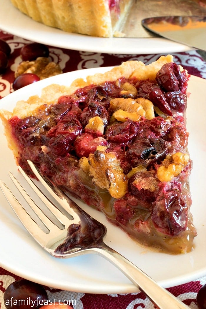 Cranberry Walnut Tart - A rich cranberry and walnut filling in a buttery shortbread shell. Perfectly sweet, tart and delicious!