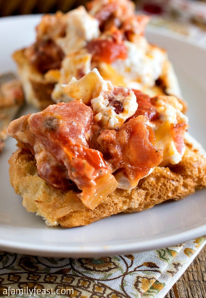Creamy Roasted Tomato Bacon Dip - Roasted tomatoes topped with a creamy bacon and cream cheese topping - plus more bacon on top! 