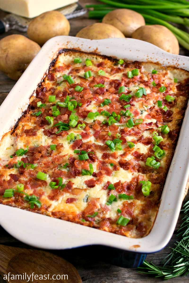 Easy Cheesy Potato Casserole - Tender slices of potato covered with a cheesy, creamy, zesty topping plus bacon and scallions! So good!