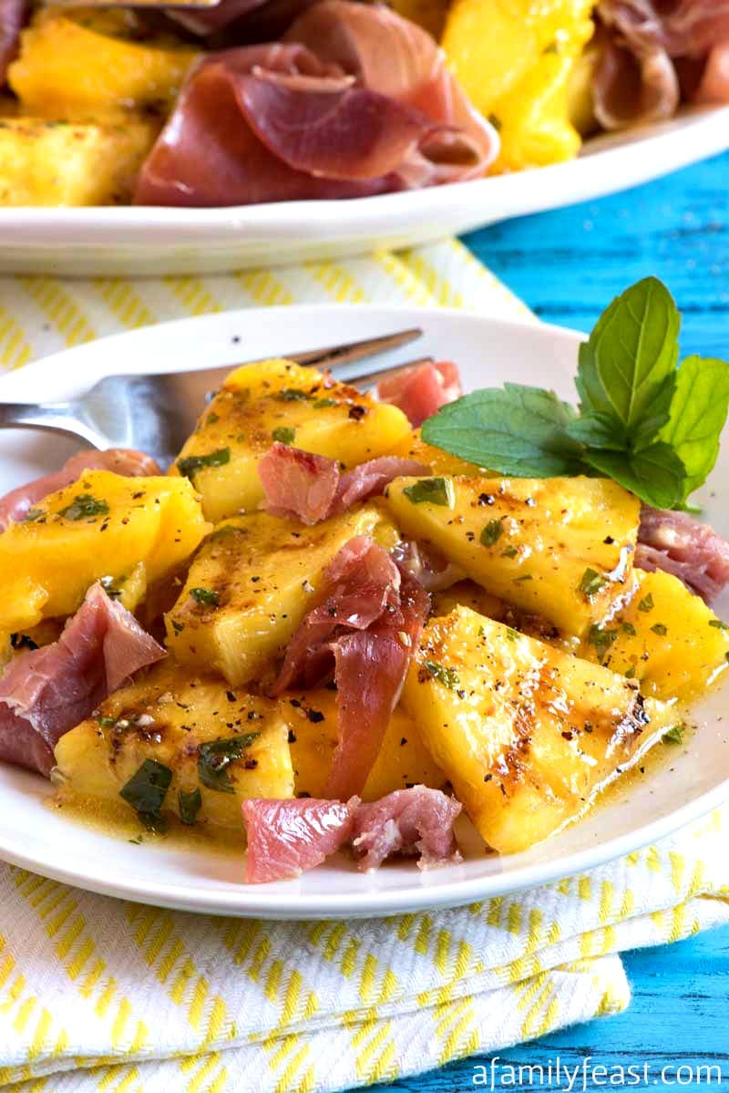 grilled pineapple with mango and prosciutto
