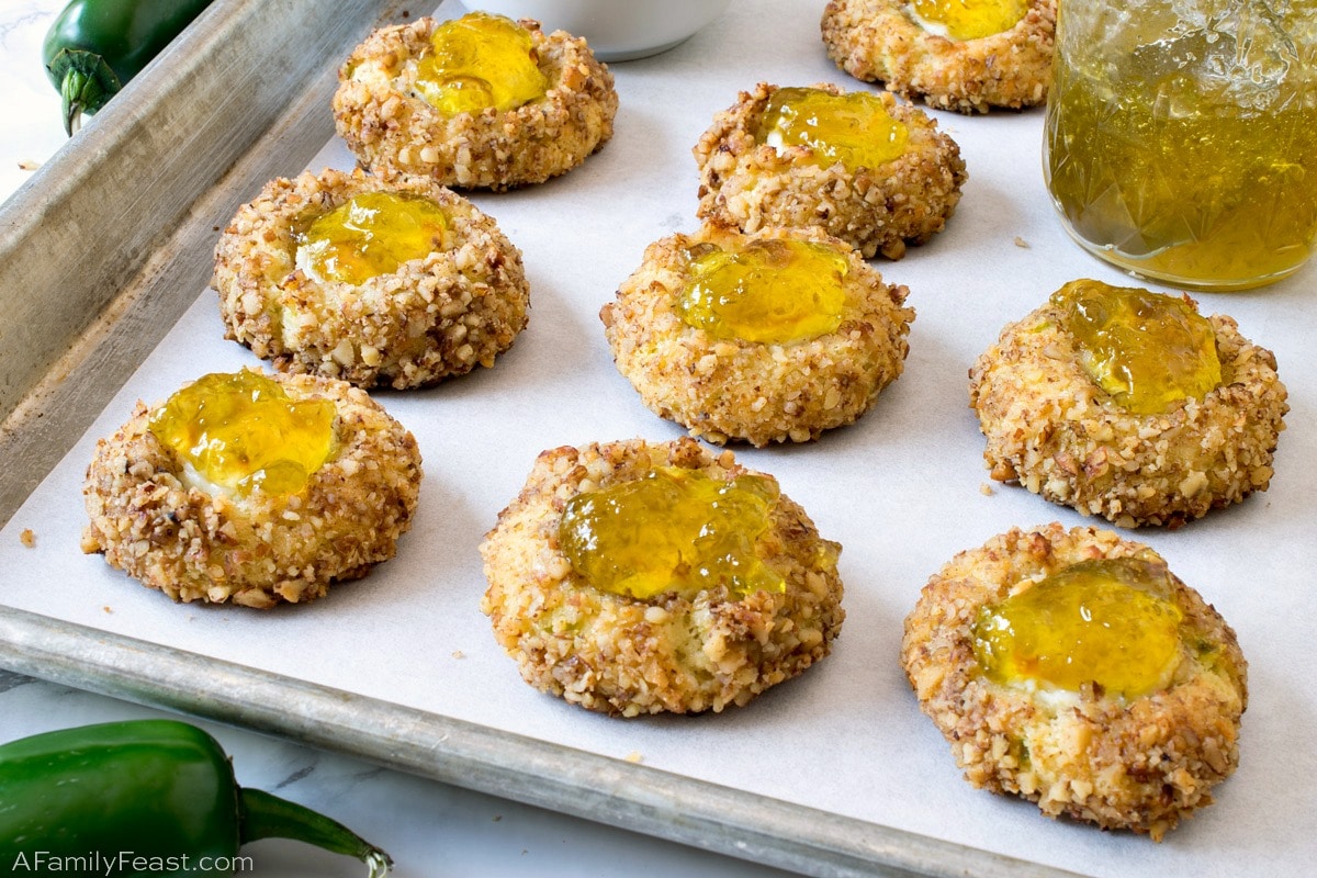 Jalapeño Popper Bites are a savory, cheddar cheese cookie filled with cream cheese and topped with homemade jalapeño jelly. Jalapeño Popper Bites