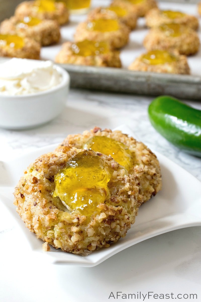 Jalapeño Popper Bites are a savory, cheddar cheese cookie filled with cream cheese and topped with homemade jalapeño jelly. Jalapeño Popper Bites