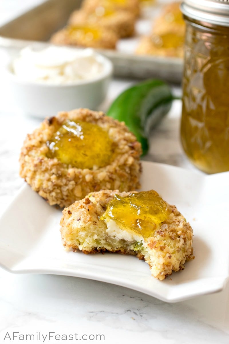 Jalapeño Popper Bites are a savory, cheddar cheese cookie filled with cream cheese and topped with homemade jalapeño jelly. Jalapeño Popper Bites