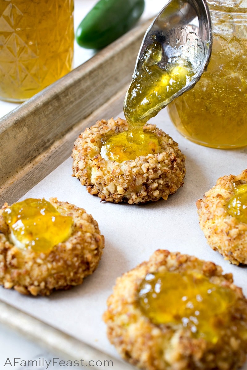 Jalapeño Popper Bites are a savory, cheddar cheese cookie filled with cream cheese and topped with homemade jalapeño jelly. Jalapeño Jelly added to Jalapeño Popper Bites