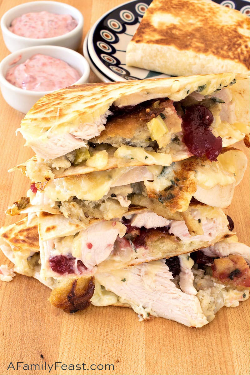 Thanksgiving Quesadillas are grilled flour tortillas piled high with slices of leftover turkey, stuffing and cranberry sauce plus fresh sage, mayonnaise and melted Monterey Jack cheese. Serve with a delicious creamy dipping sauce. Thanksgiving Quesadillas
